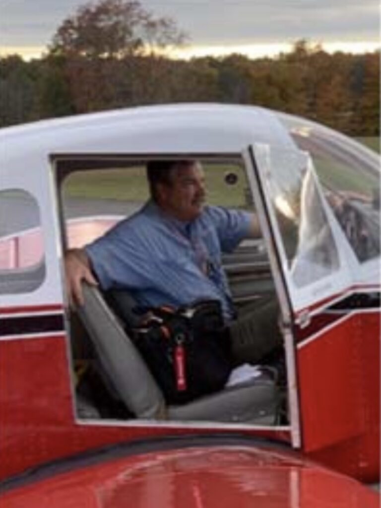 Bob Prange, the president of EAA, in the cockpit of a plane.