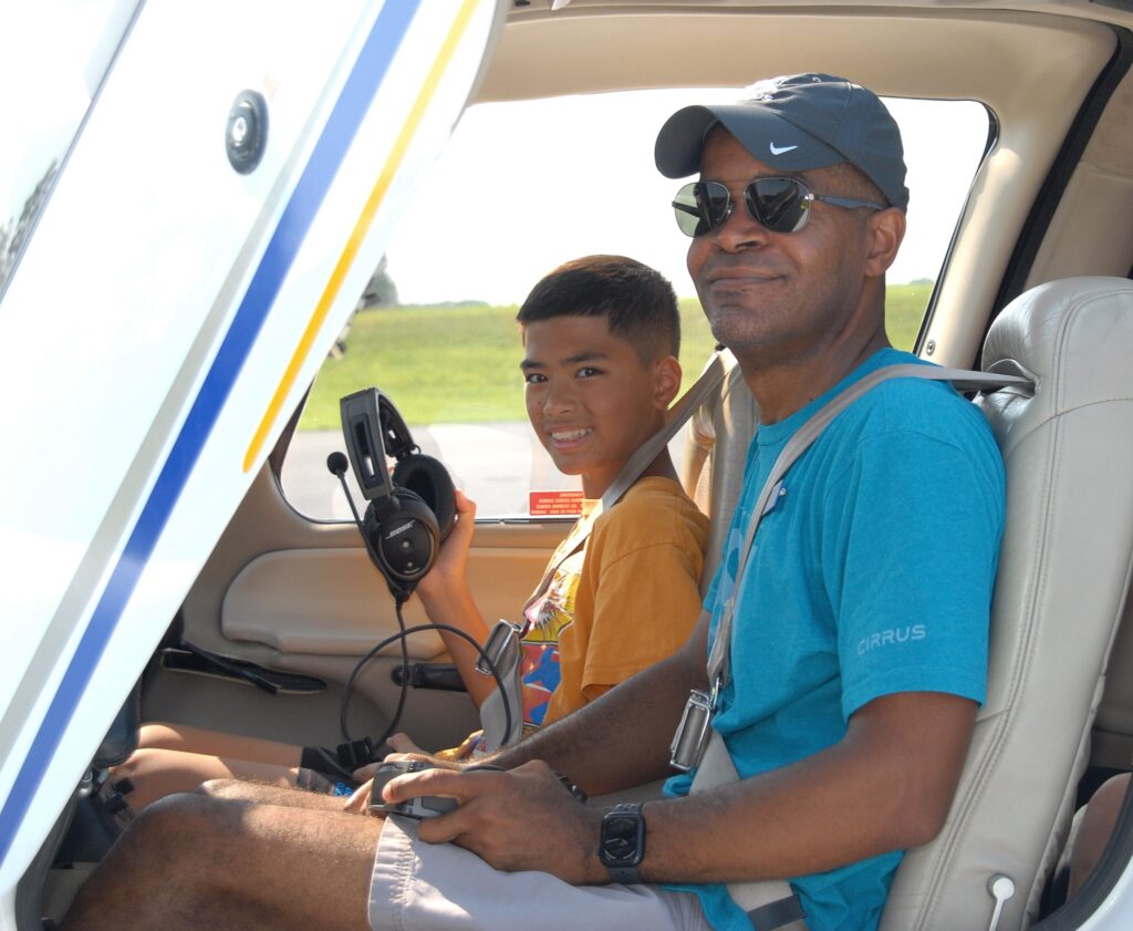 Black Pilot and kid really happy that they are getting ready to fly