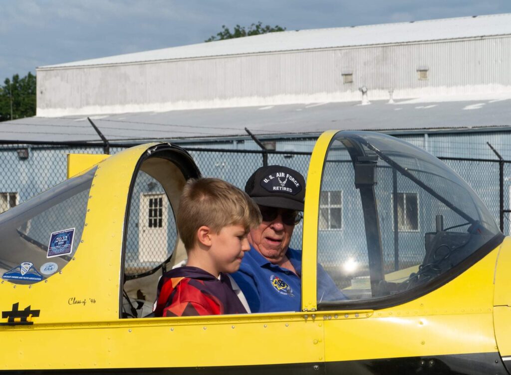 Kid flying a plane with an instructor